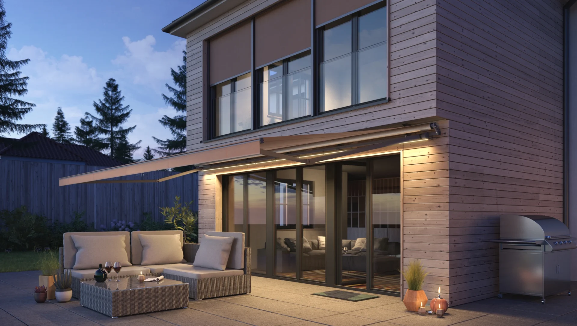 Moderne Terrasse mit gemütlicher Sitzgruppe und Beleuchtung bei Abenddämmerung